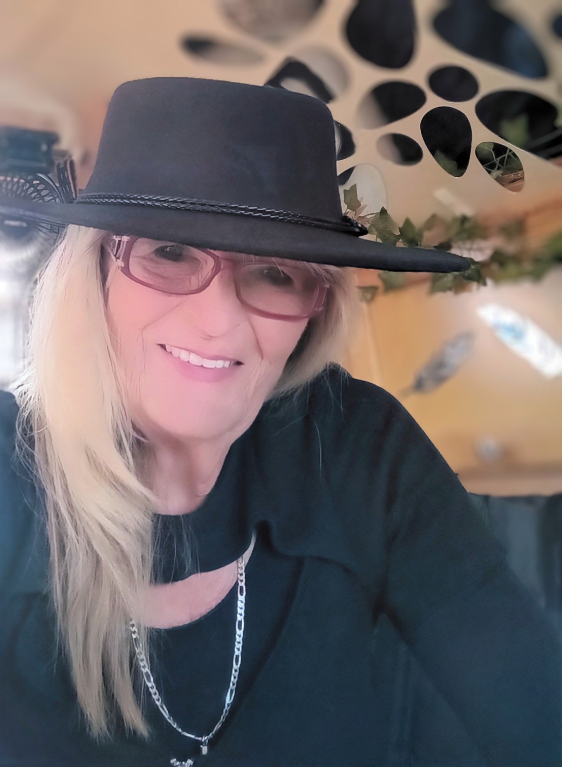 Jo smiling in a black hat inside her T@B camper